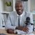 smiling-man-in-gray-suit-at-office-desk-2026-01-09-11-05-52-utc-1.jpg